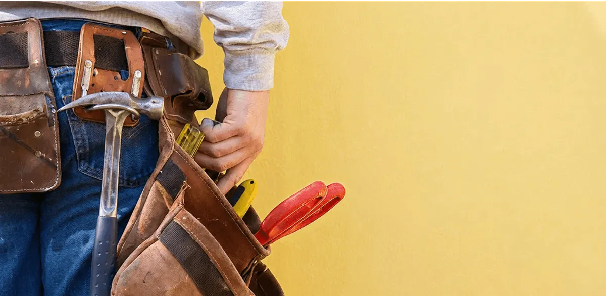 Handyman with tool belt ready for home repairs and maintenance in Fresno, CA